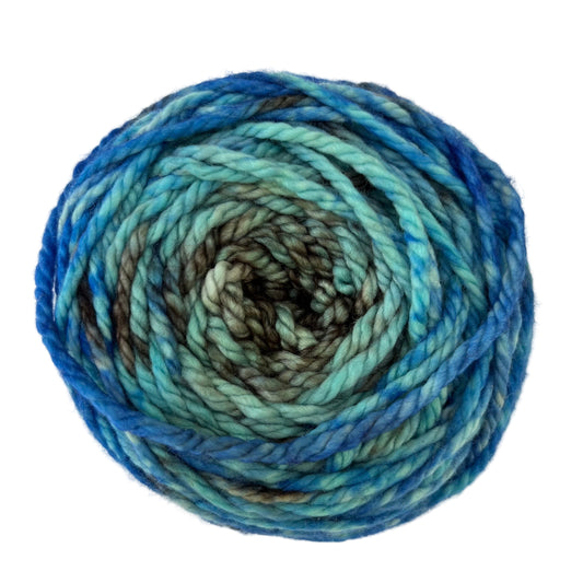 Top view of hand-dyed yarn multicolored blue, light blue, brown.