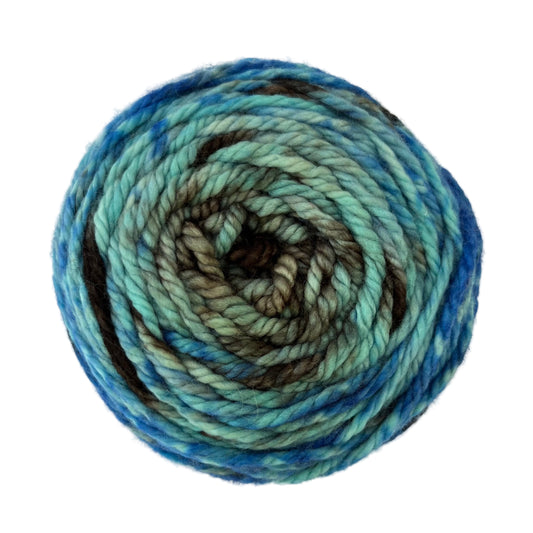Top view of hand-dyed yarn multicolored blue, light blue, brown. 